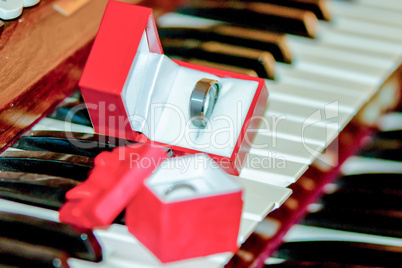 two wedding bands on piano keys