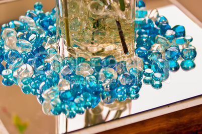 blue marbles on a reflective surface