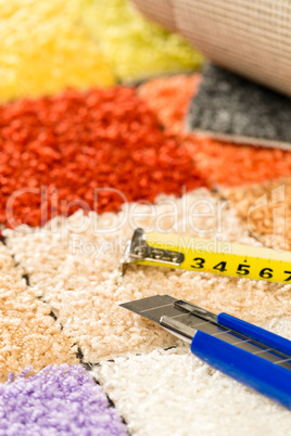 Carpet swatches, knife and tape measure