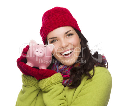 Happy Mixed Race Woman Wearing Winter Hat Holding Piggybank