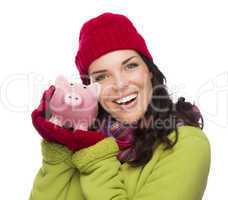 Happy Mixed Race Woman Wearing Winter Hat Holding Piggybank