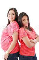 beautiful hispanic pregnant woman with her daughter