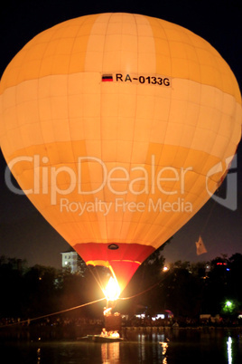 hot air baloon landing on the lake