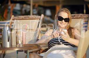 woman sending an sms on her mobile