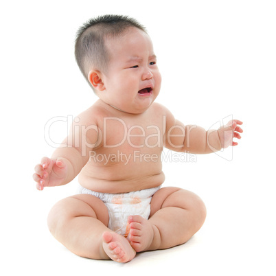 Crying Asian baby boy requests for food