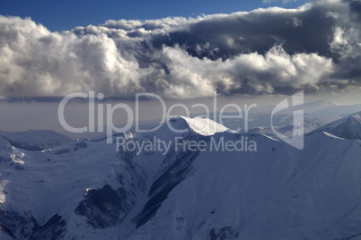 Winter mountains in evening and cloudy sky