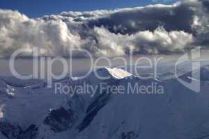 Winter mountains in evening and cloudy sky