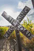 Antique Country Rail Road Crossing Sign Near a Corn Field.