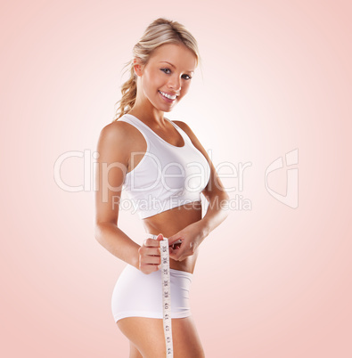 beautiful woman measuring her waist