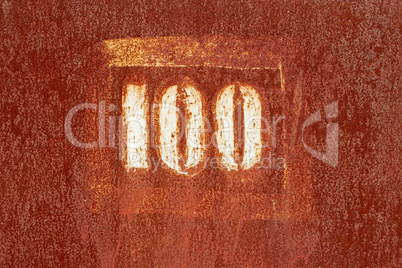 number 100 painted on an old rusty surface