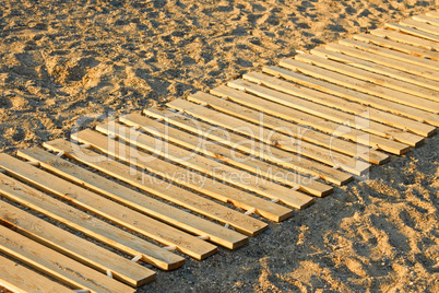 wooden mat on a sandy beach