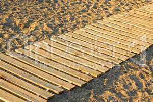 wooden mat on a sandy beach
