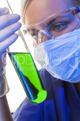 Female Scientist & Green Test Tube In Laboratory