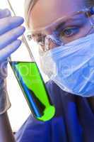 Female Scientist & Green Test Tube In Laboratory