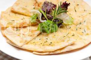 garlic pita bread pizza with salad on top