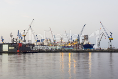 shipyard with ships and cranes