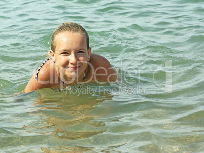 teenage girl swimming in seawater