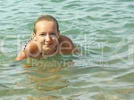 teenage girl swimming in seawater