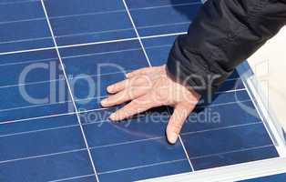 Hand on solar panel