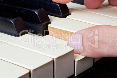 piano keyboard made of ivory with hands