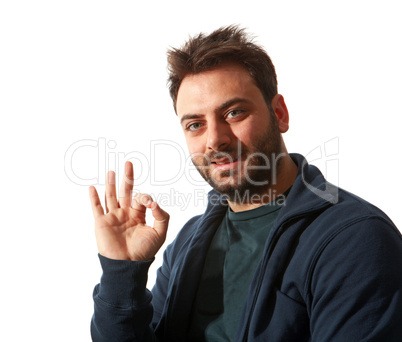 Smiling young man gesturing ok sign