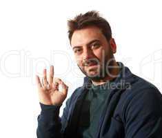 Smiling young man gesturing ok sign