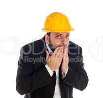 Frightened businessman with construction helmet