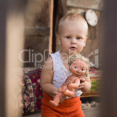 the little boy plays with a doll