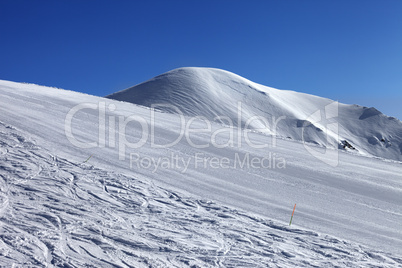 ski slope and blue cloudless sky in nice winter day