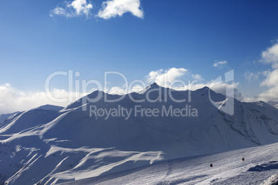 view on ski slope and beautiful mountains in evening