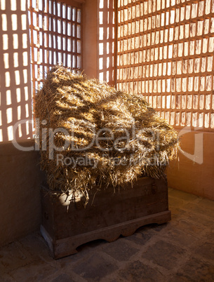 Barn with the sun  from outside and straw and hay