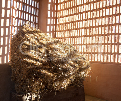 Barn with the sun  from outside and straw and hay