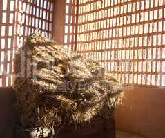 Barn with the sun  from outside and straw and hay