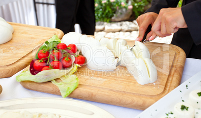 Sliced of mozzarella on a wooden plate
