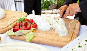 Sliced of mozzarella on a wooden plate