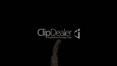 Masked criminal rising from darkness with chopper knife