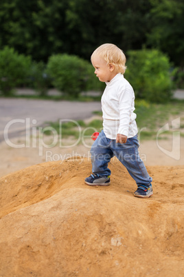 baby boy playing in the sandbox