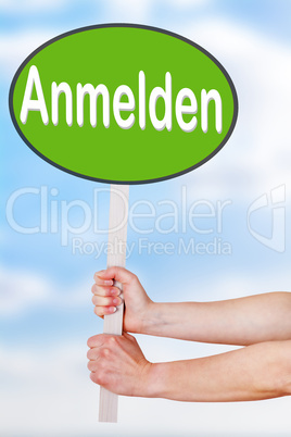 Hands holding a sign with the word anmelden
