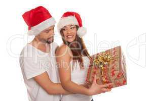 couple looking through frame wearing santa hats