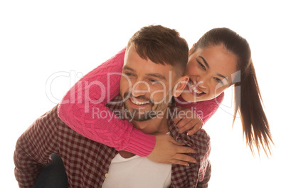 playful young couple with woman riding piggyback