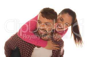 playful young couple with woman riding piggyback