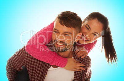 playful young couple with woman riding piggyback