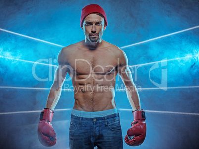 young athletic boxer in a smoky background