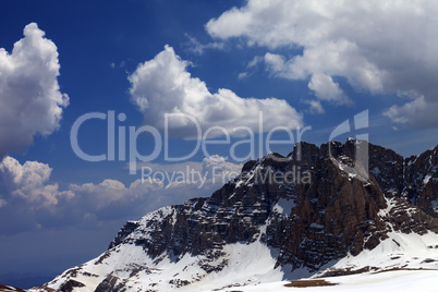 blue sky with clouds and snow rocks