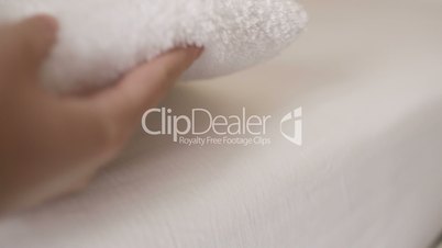 Woman smoothing a fresh white towel