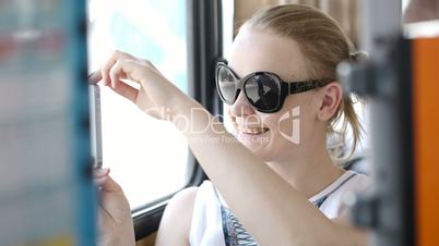 Woman taking pictures at her mobile on a bus