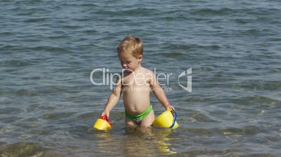 adorable little boy playing in the sea