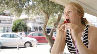 Woman eating refreshments in a cafeteria