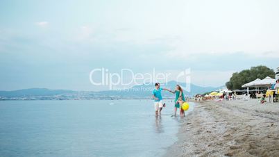 young family enjoying a summer at the seaside