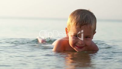 smiling little boy in the sea